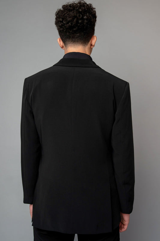 Man wearing a concert black tuxedo with black dress pants