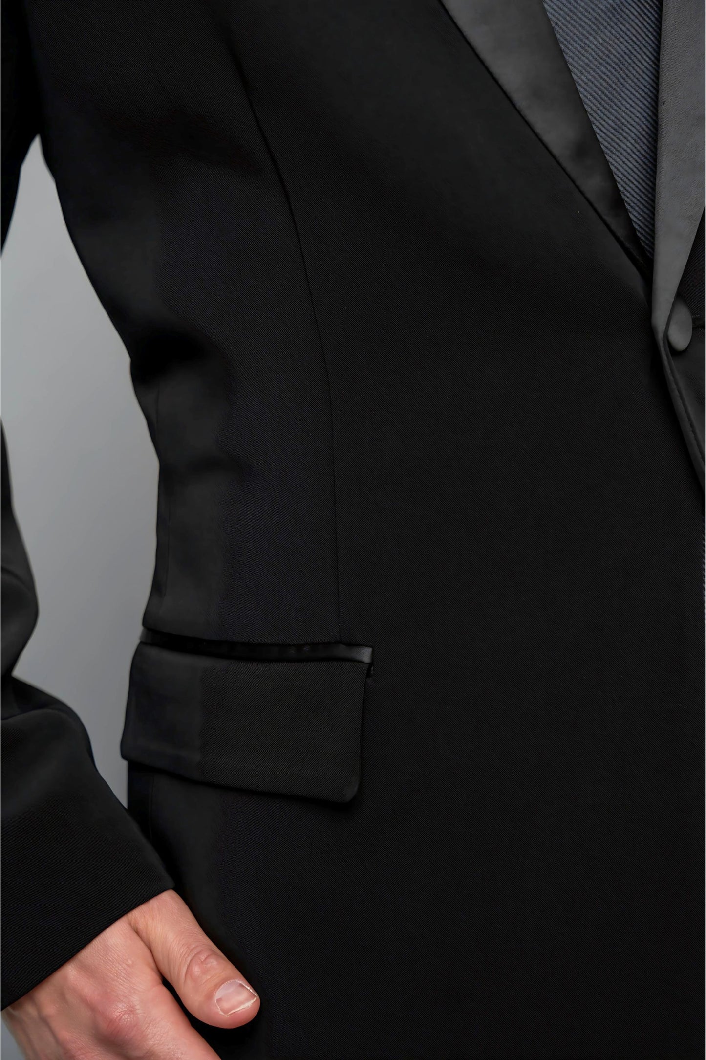 Man wearing a concert black tuxedo with black dress pants