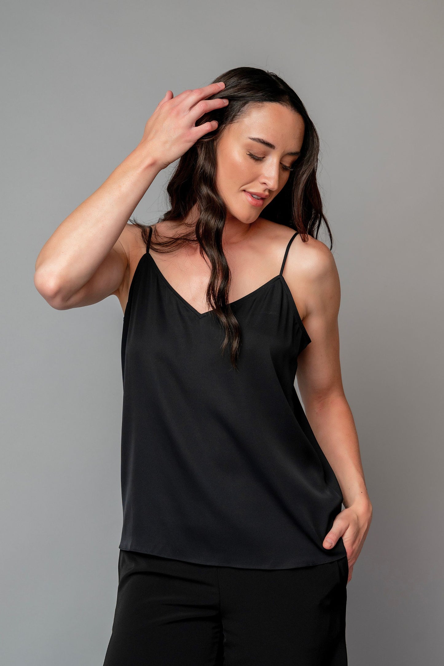 Woman wearing a black spaghetti strap top for choir, band, and orchestra musicians