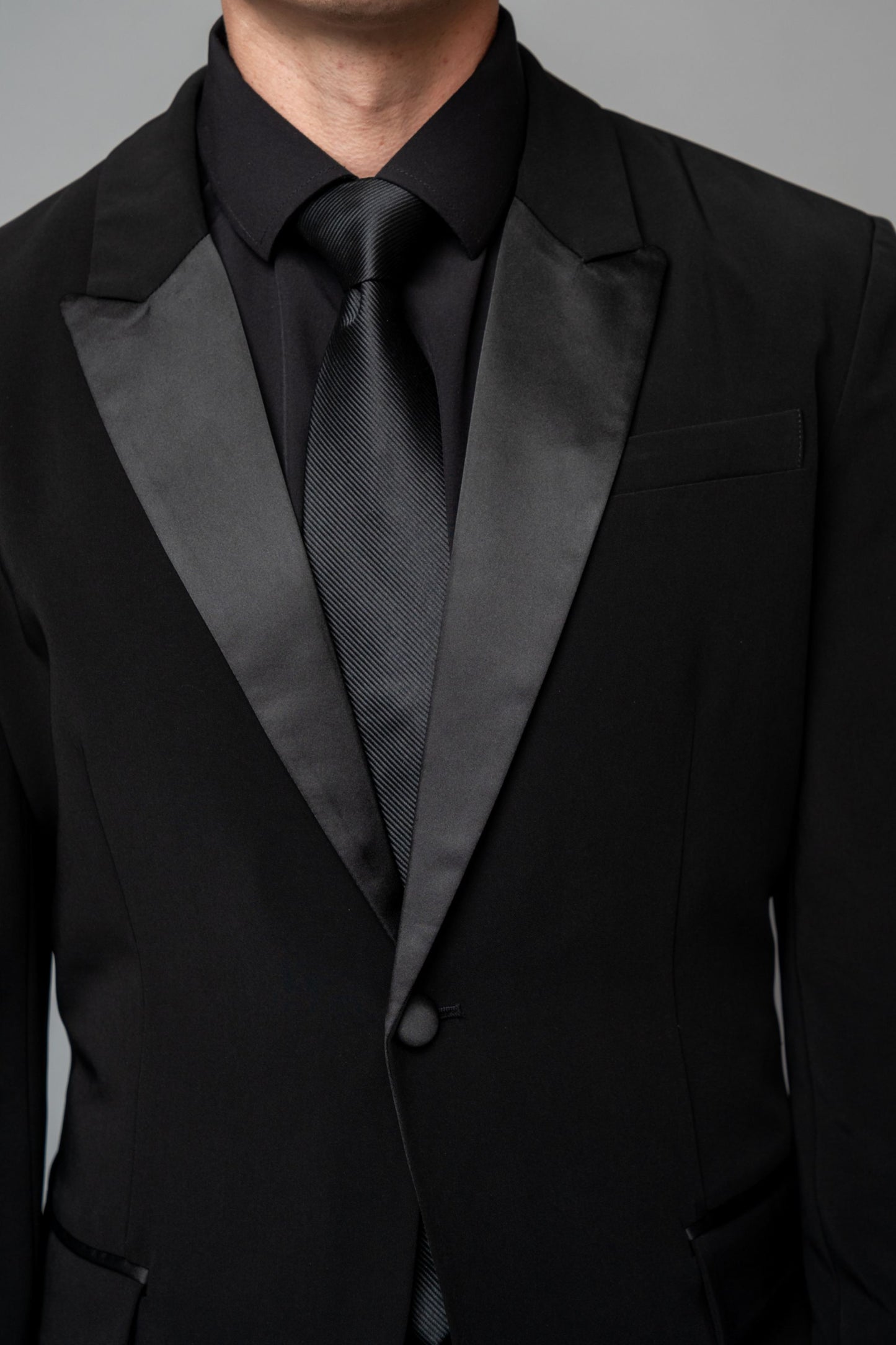 Man wearing a concert black tuxedo with black dress pants