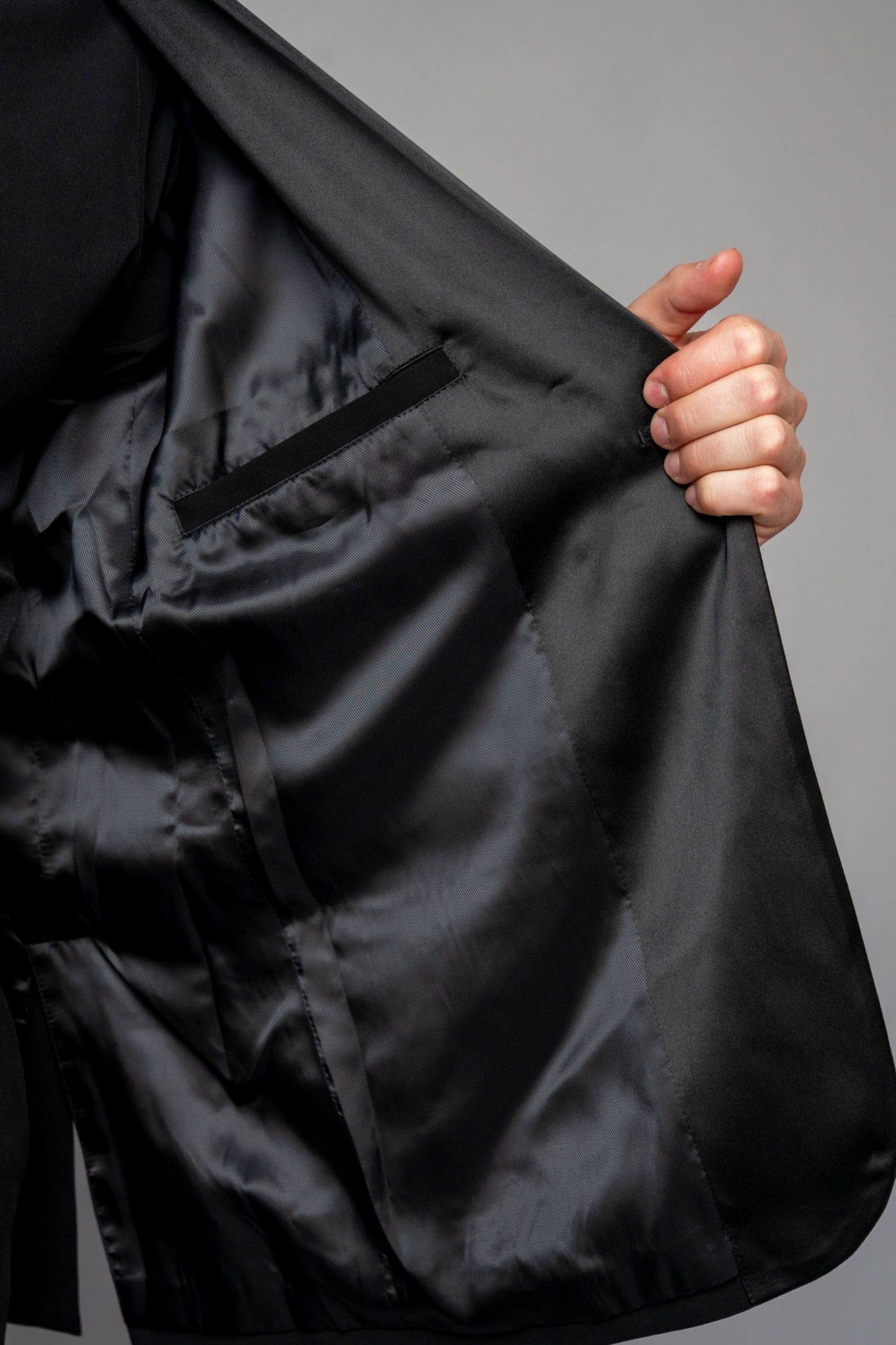 Man wearing a concert black tuxedo with black dress pants
