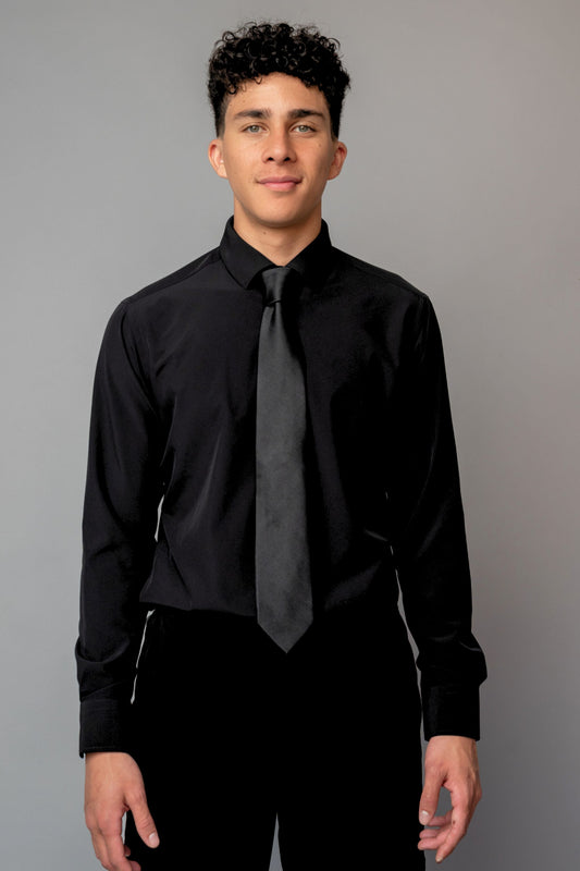 Man wearing a black dress shirt and tie against a gray background