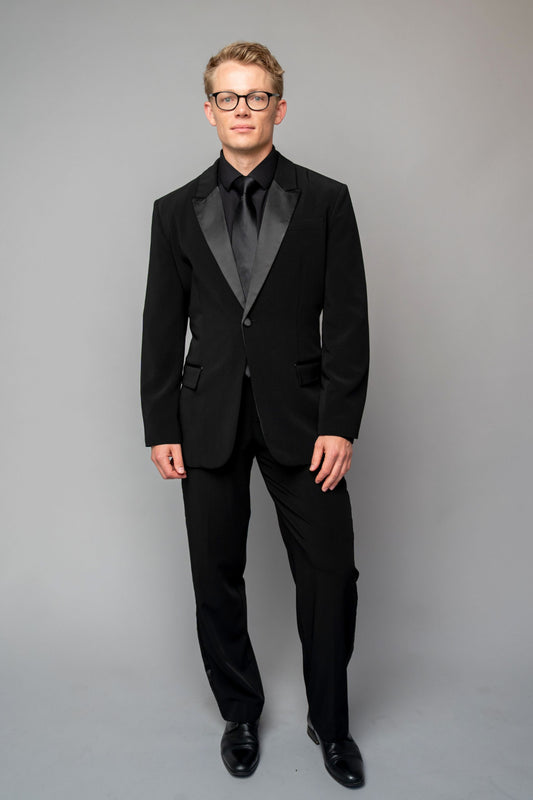 Man wearing a concert black tuxedo with black dress pants